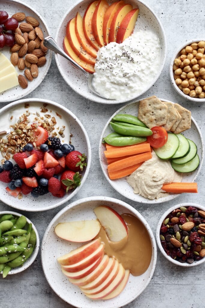 Overhead view several bowls filled with different snack ideas