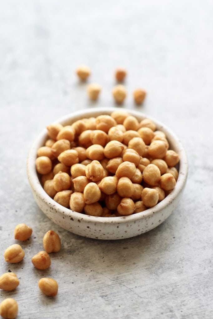 stone bowl filled with crispy roasted chickpeas for healthy snacks