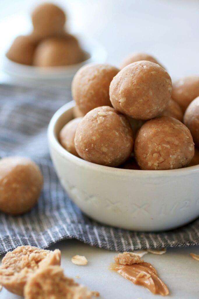 Side view no bake peanut butter bites in white bowl