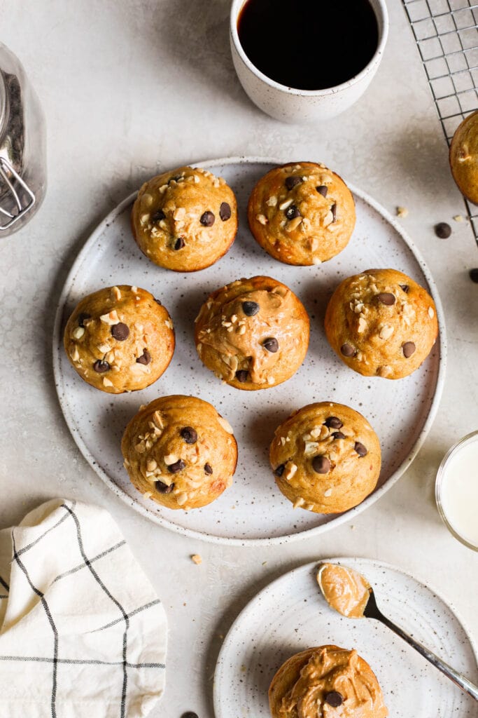 Overhead view protein muffins on stone plate topped with chocolate chips and peanuts