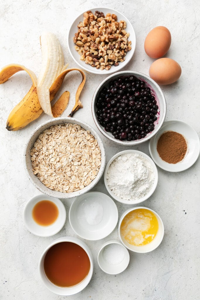 All ingredients for oatmeal breakfast bars arranged together in small bowls