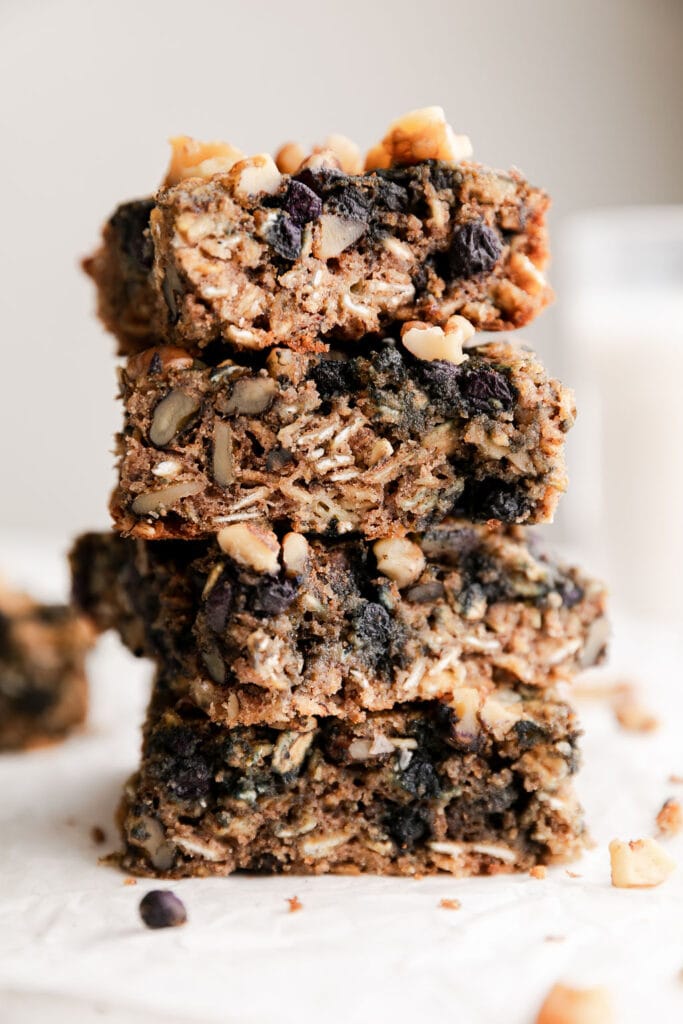 Oatmeal breakfast bars cut into squares stacked up on each other.