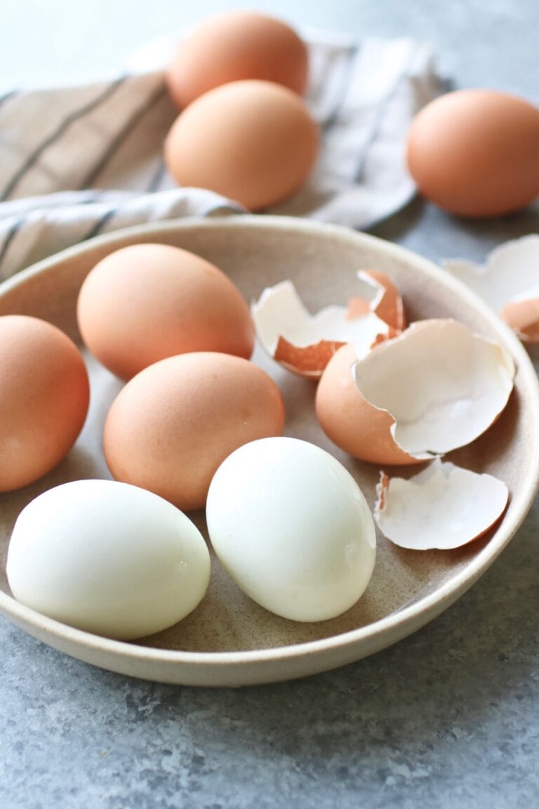 Close up view of a dish of hard boiled eggs.