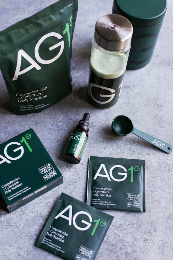 AG1, formerly Athletic Greens, supplements in to-go packets, a dropper bottle, bulk pouch, and mixed into a water bottle. 