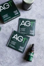 Athletic Green's AG1 Single Use Packets and the AG1 dropper bottle.