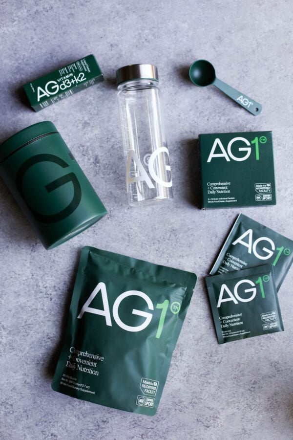 AG1 supplements in various sized packaged on a counter top.