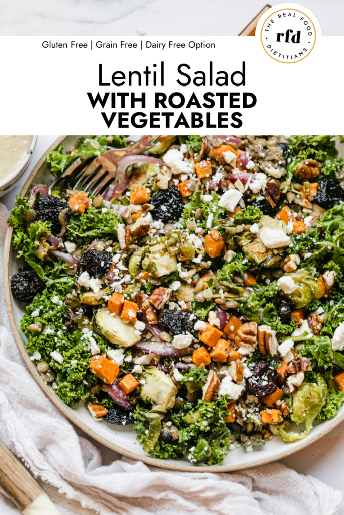 Close up overhead view serving bowl filled with lentil salad with roasted vegetables and feta cheese