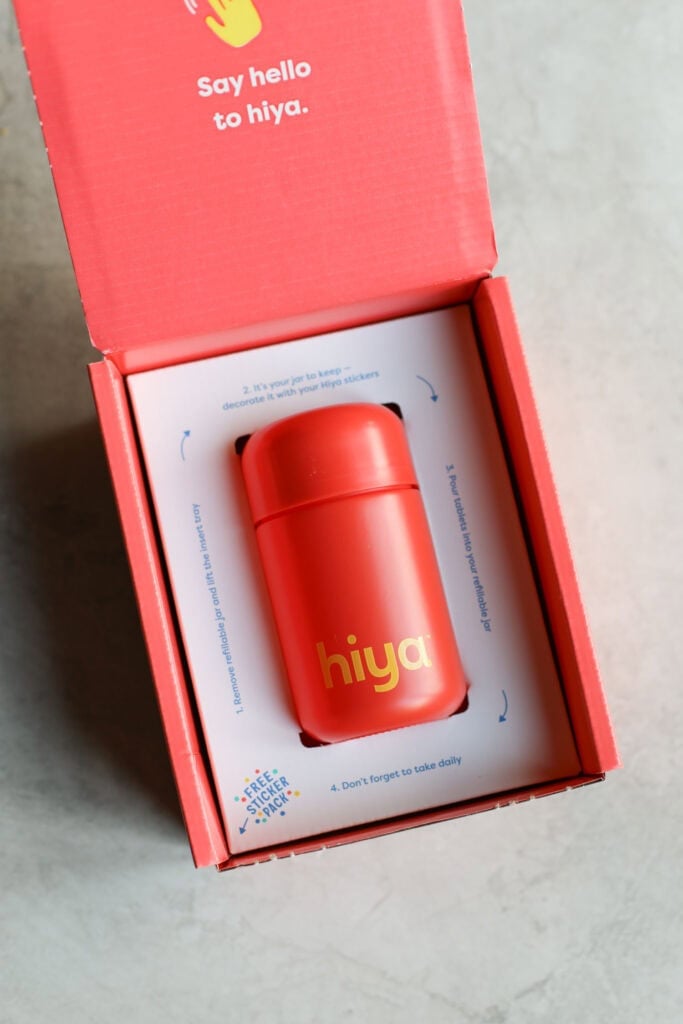 Red box packaging for Hiya kids daily iron plus supplement on countertop.