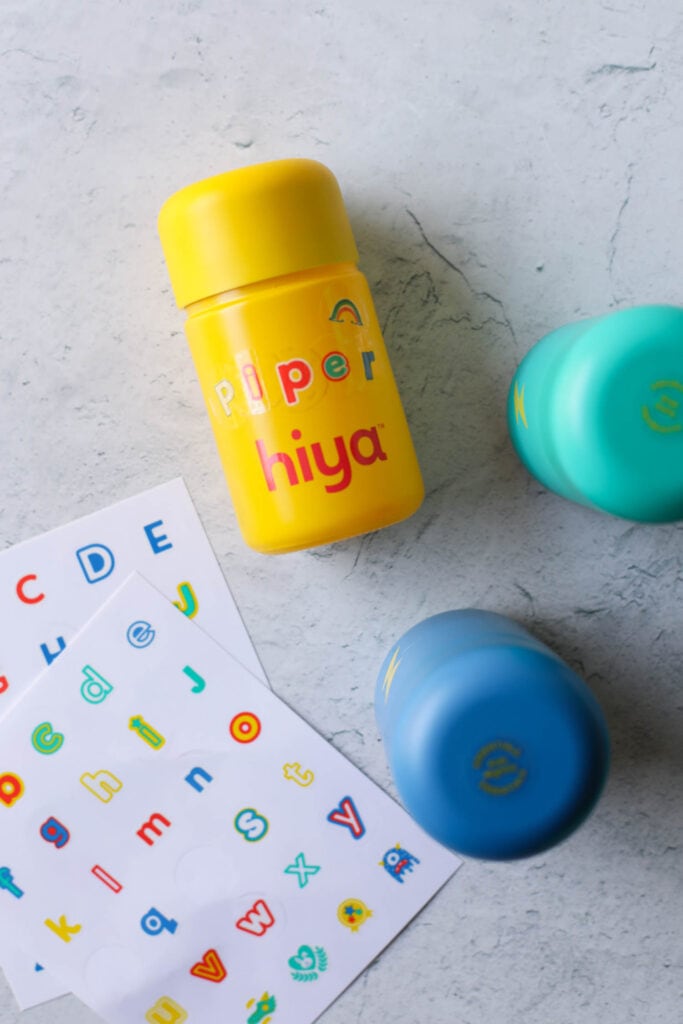Yellow bottle of Hiya kids multivitamin with stickers on bottle to spell out the name "piper"