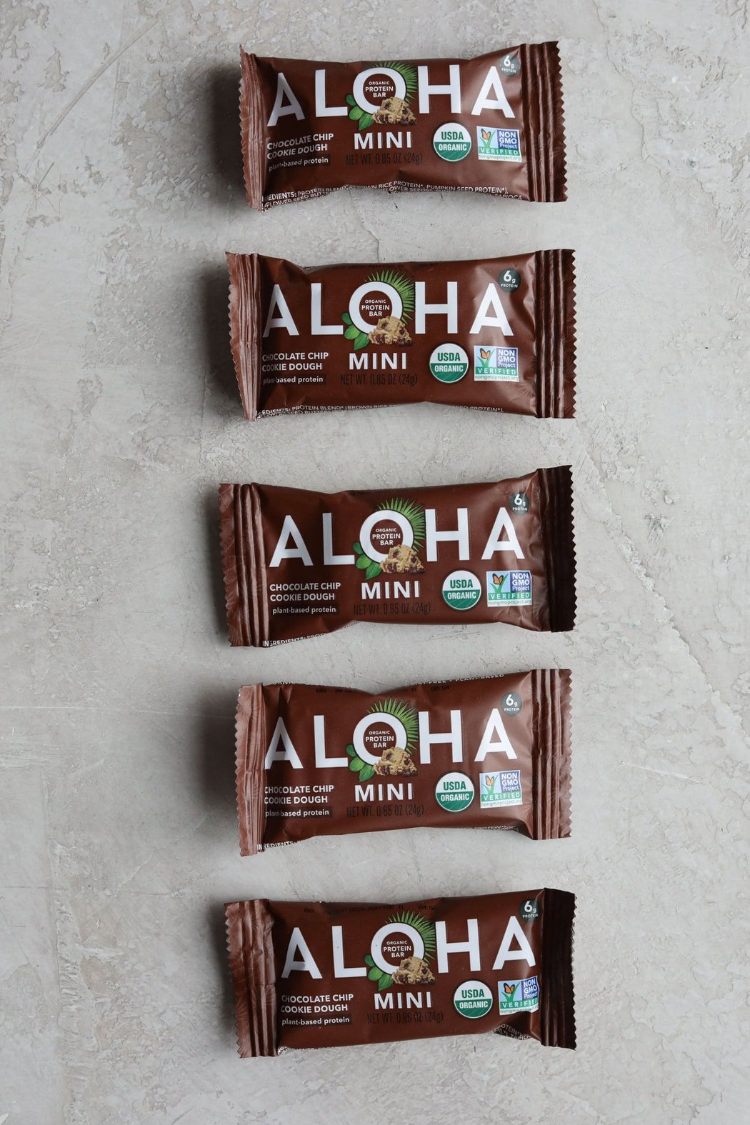 Overhead view of a row of aloha mini protein bars on a countertop. 