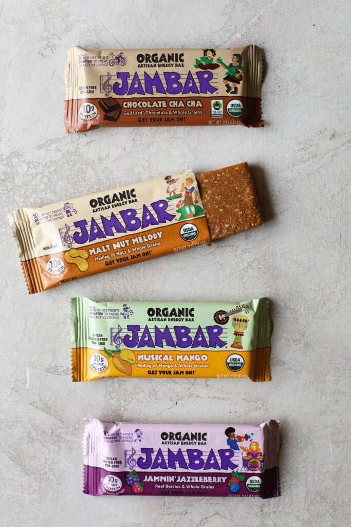 Overhead view Jambar protein bars on countertop with one package open to show inside protein bar