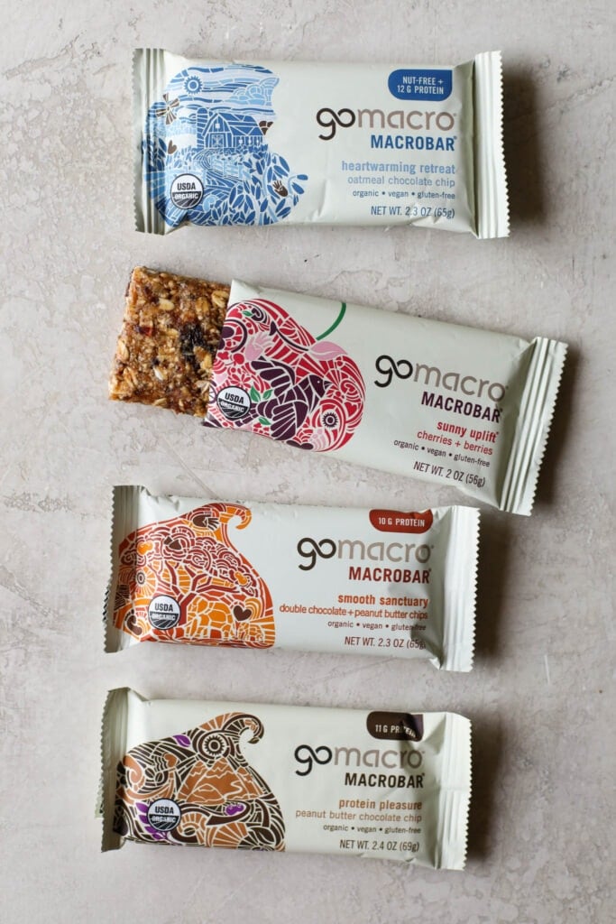 Overhead view Go Macro protein bars on countertop with one package open to show protein bar