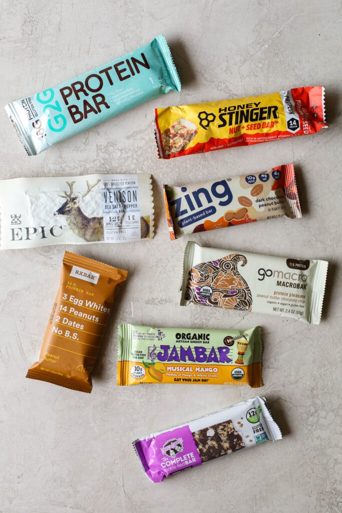 Overhead view several protein bars arranged together on countertop for a protein bar review