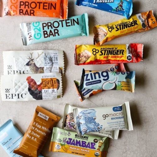 Overhead view several protein bars arranged together on countertop for a protein bar review