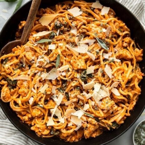 Overhead view pumpkin pasta with sausage in a cast iron skillet