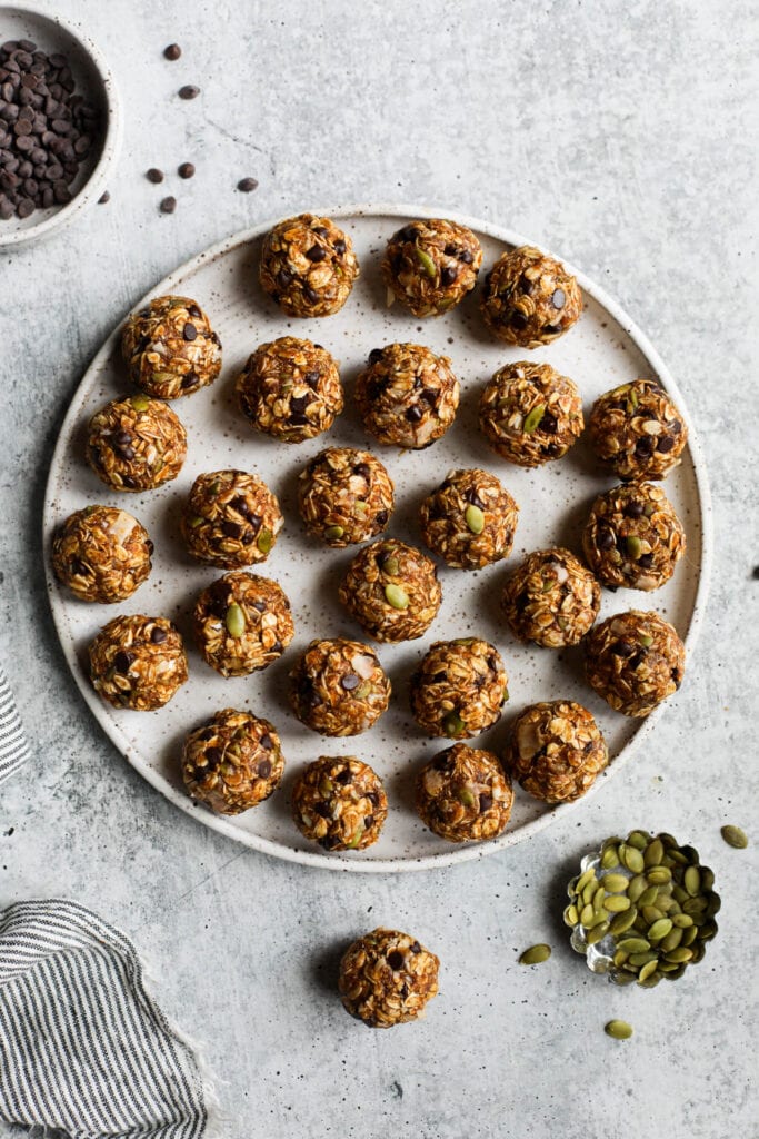 Overhead view round stone plate filled with pumpkin protein balls