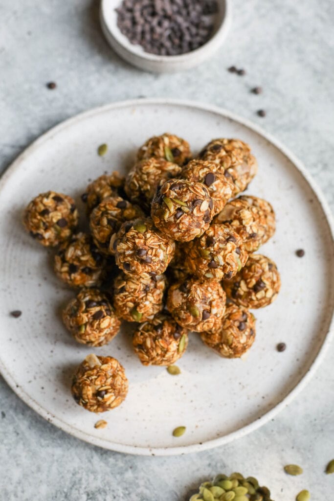 overhead view pumpkin protein balls stacked up in pile on stone serving plate