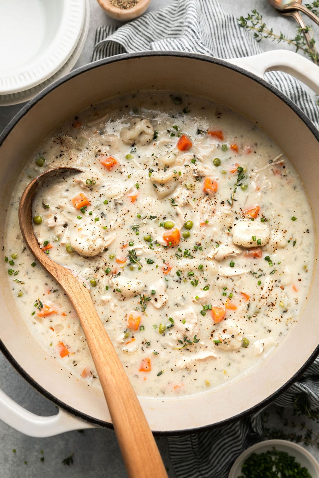 An overhead view of a pot of Chicken and Dumpling soup ready to be ladled into bowls.