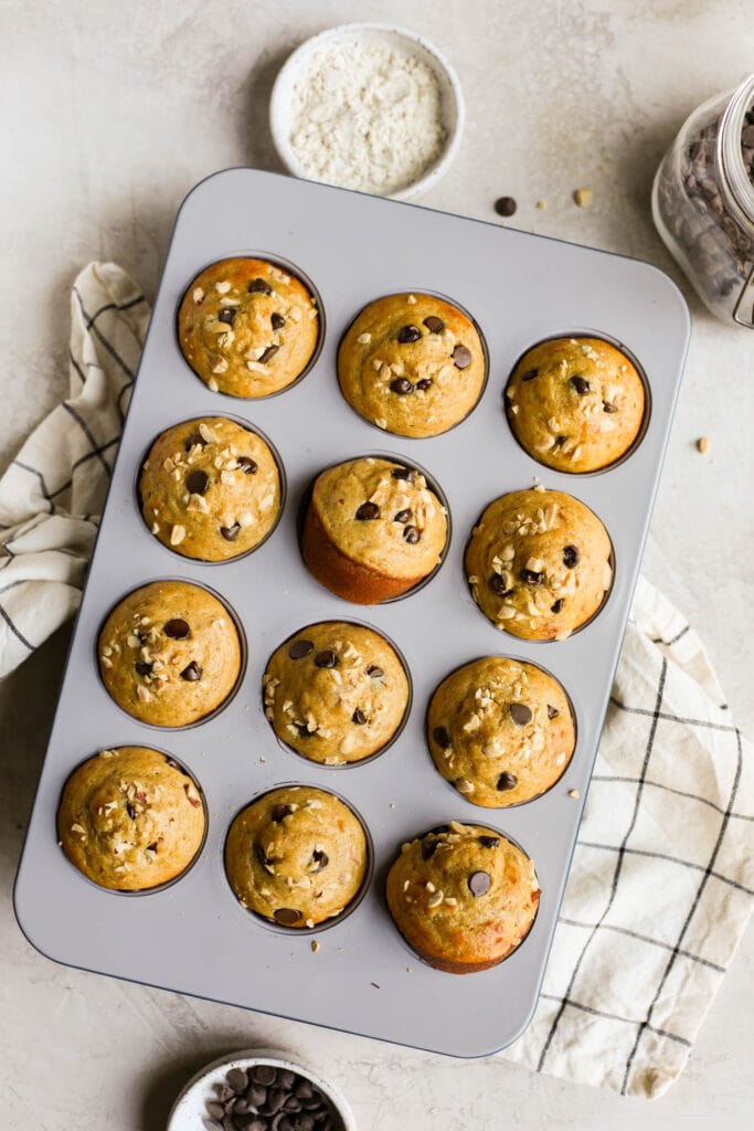 Overhead view Caraway muffin tin filled with peanut butter protein muffins with chocolate chips
