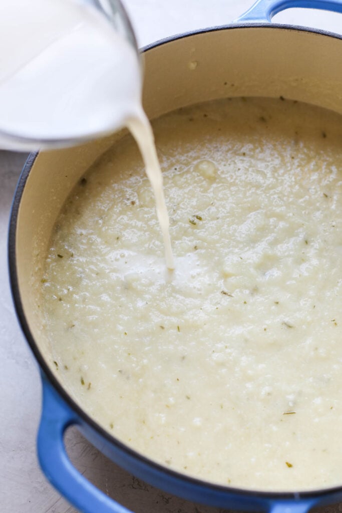 Milk being stirred into the Cauliflower Soup recipe. 