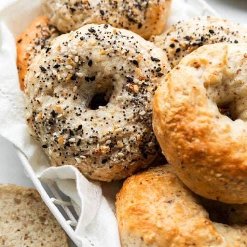A close-up view of the freshly baked Greek yogurt bagels, some with Everything Bagel Seasoning and others are golden brown plain bagels.