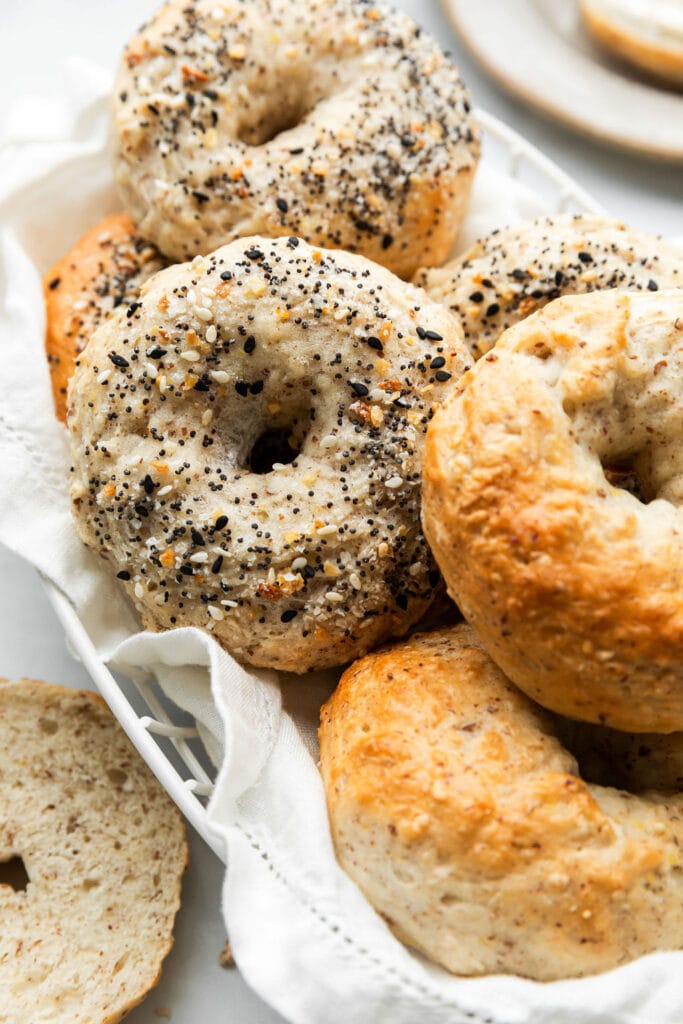 A close-up view of the freshly baked Greek yogurt bagels, some with Everything Bagel Seasoning and others are golden brown plain bagels. 