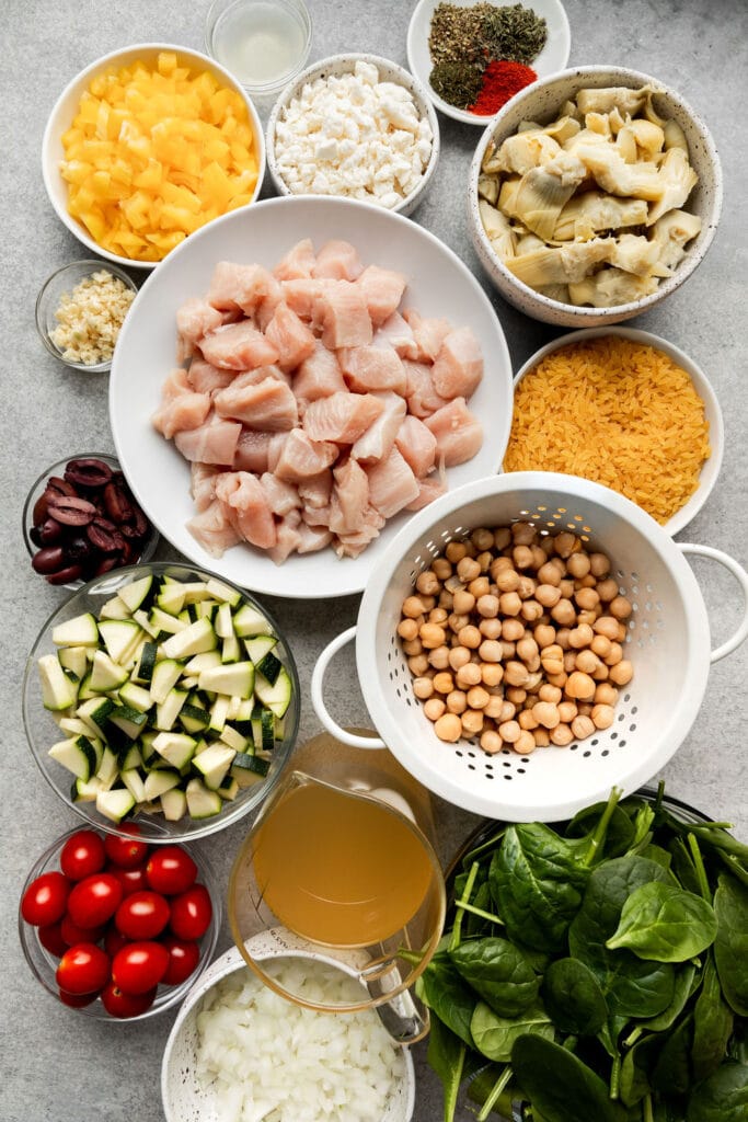 Overhead all ingredients for Greek Orzo arranged in small bowls