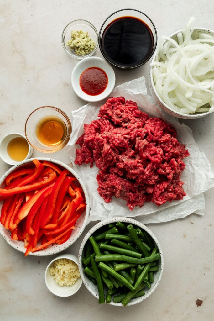 Overhead view of ingredients for Ground Beef Stir Fry in various bowls and cups. 