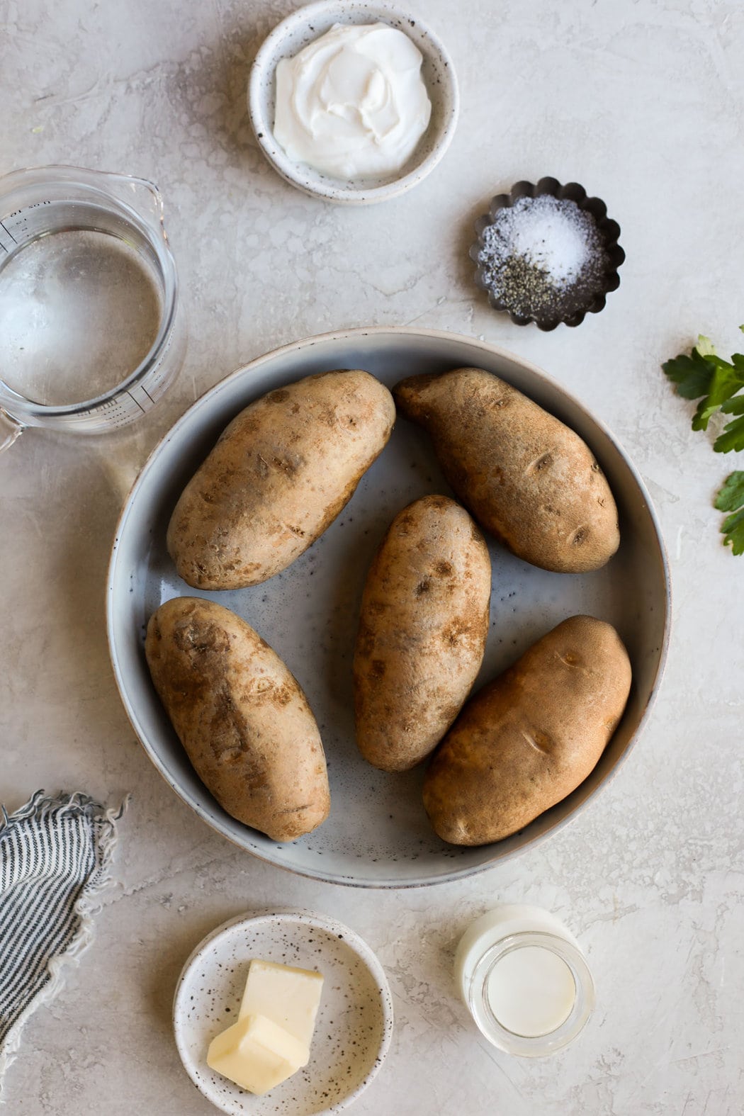 Overhead view of a variety of ingredients for Instant Pot Mashed Potatoes. 