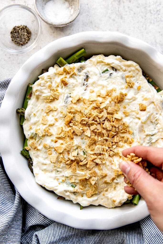Sour cream mixture spread over fresh asparagus with hand sprinkling crushed crackers over the top.