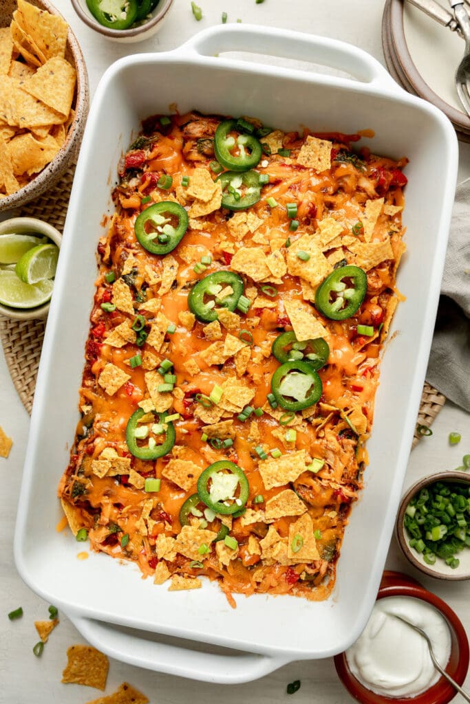 Overhead view of a freshly baked King Ranch Casserole topped with sliced jalapeno and green onions. 