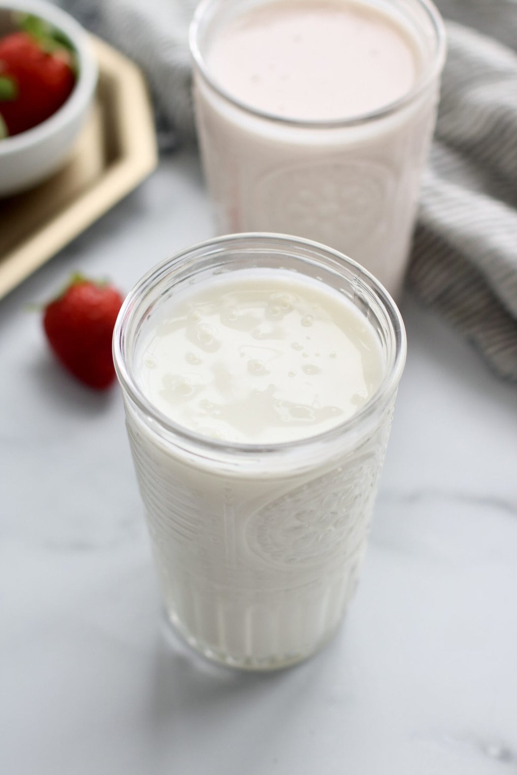Overhead view of two glasses of kefir. 