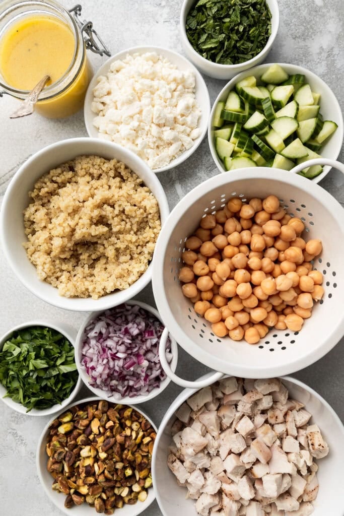 Overhead view of a variety of bowls containing ingredients for Jennifer Aniston salad. 