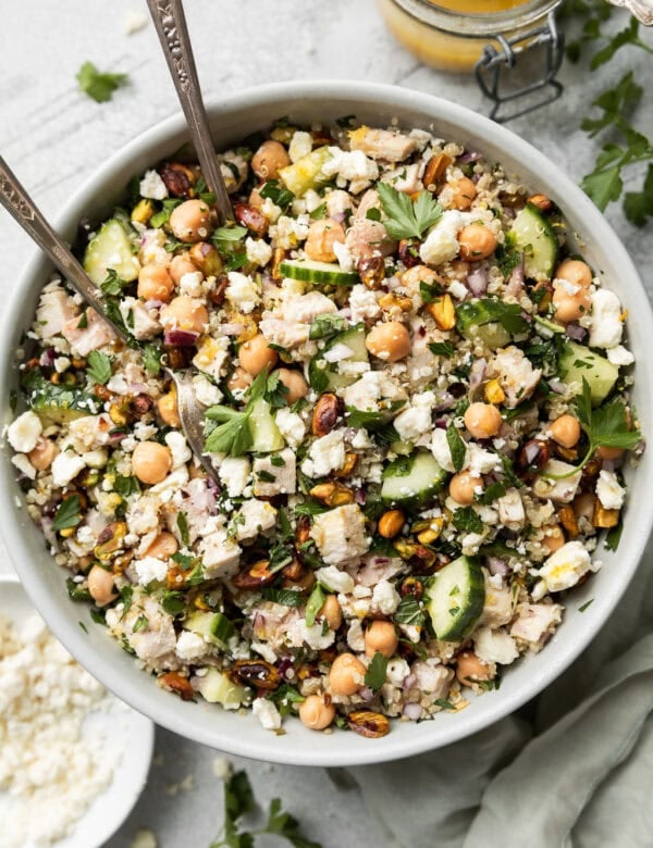 Overhead view Jennifer Aniston salad with chicken and chickpeas in white serving bowl