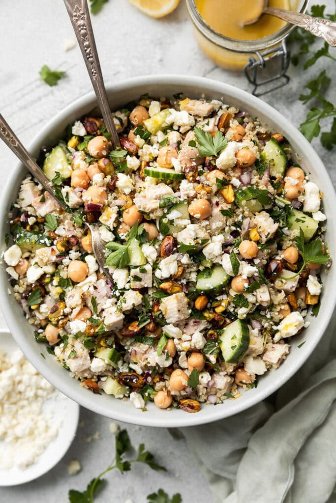 Overhead view Jennifer Aniston salad with chicken and chickpeas in white serving bowl