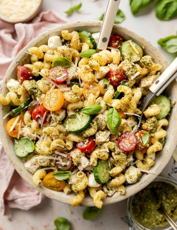 Overhead view stone bowl filled with chicken pesto pasta salad