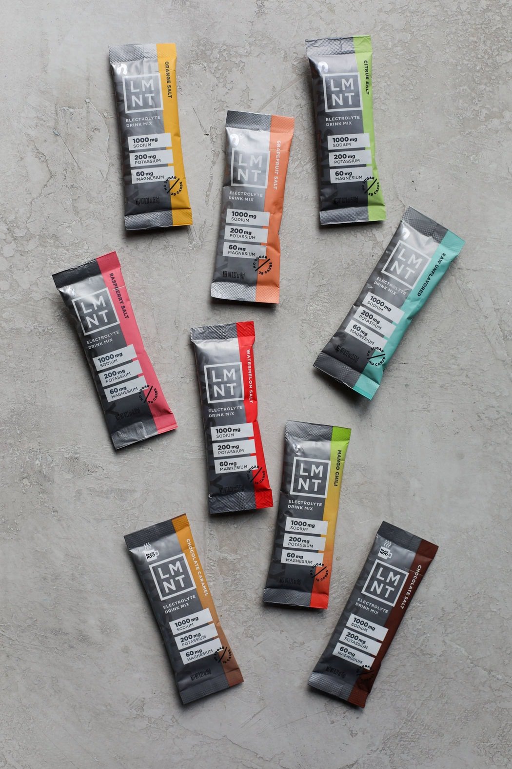 A variety of LMNT packets and flavors on a marble background. 