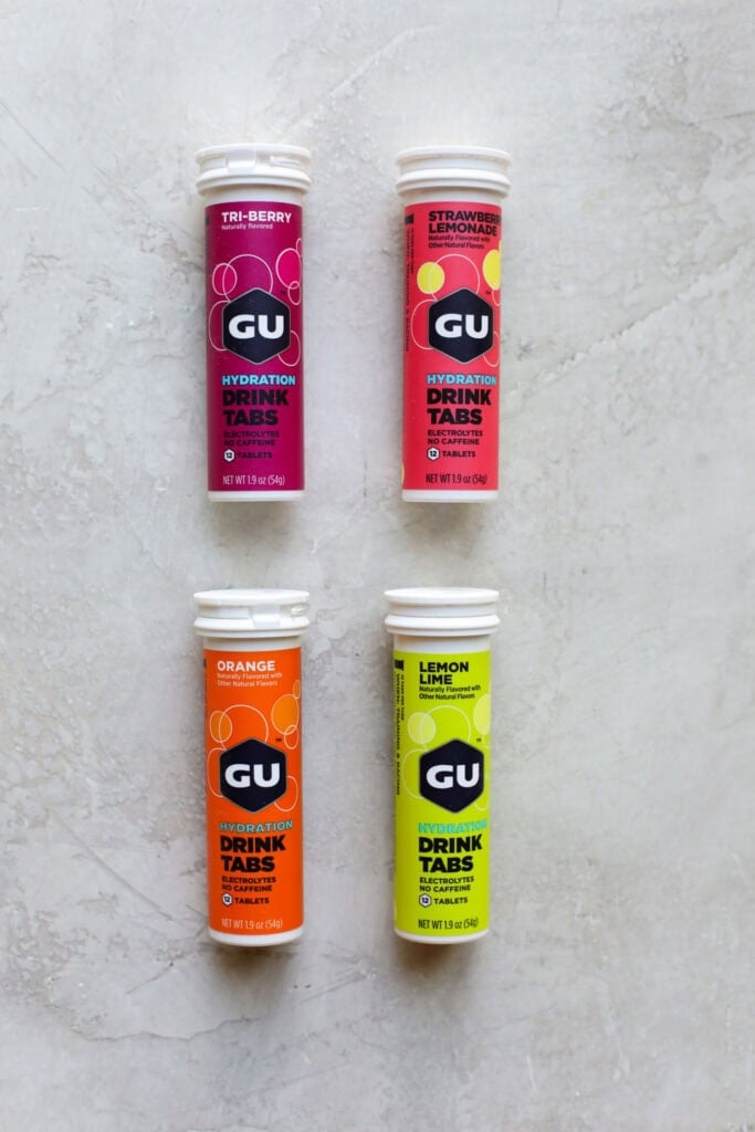 Four tubes of GU hydration tabs in a variety of colors and flavors. 