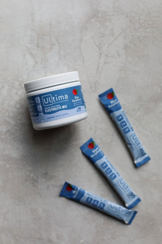 A canister and individual sticks of ultima electrolyte drink mix. 