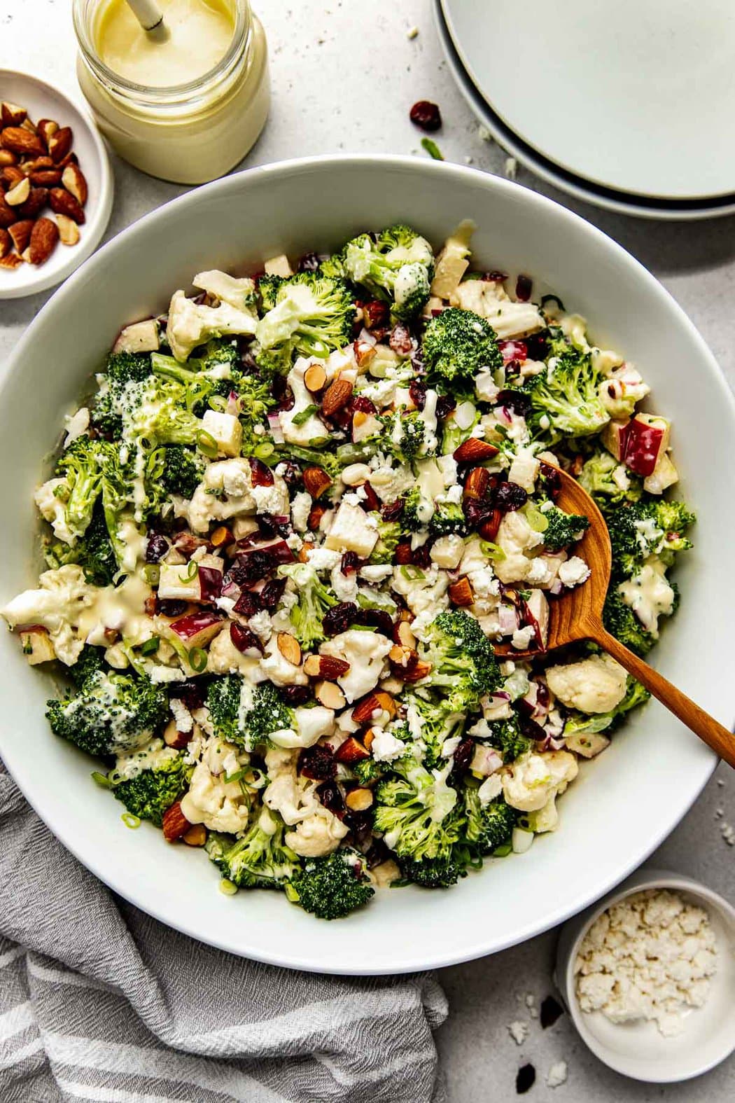 Overhead view apple broccoli salad with cranberries and cauliflower in a large serving bowl
