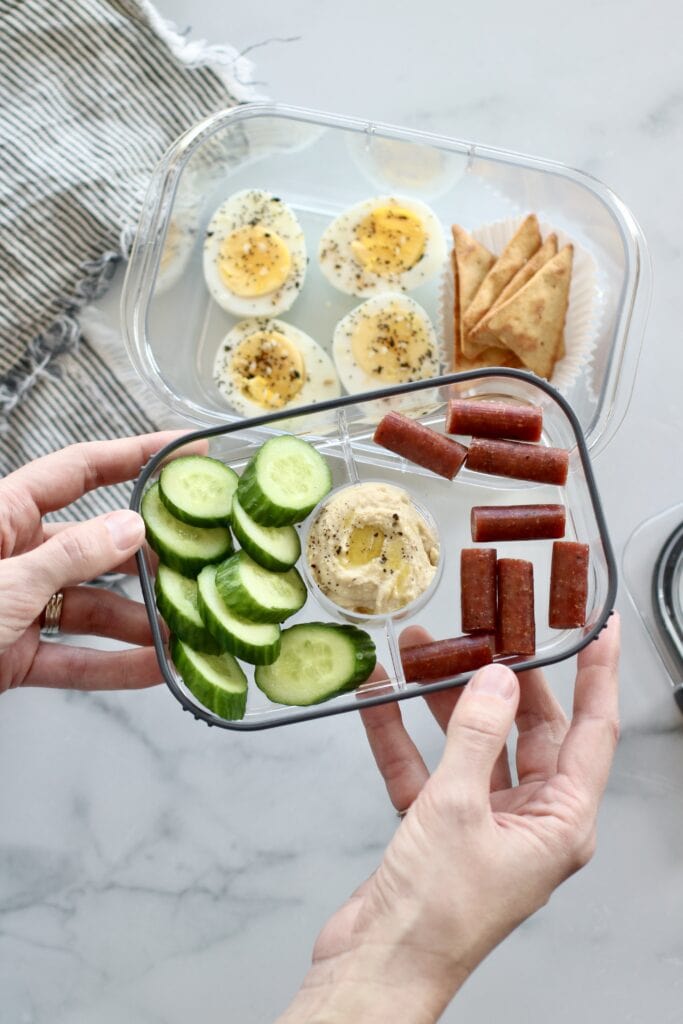 Overhead view of compartment meal prep container filled with healthy food options in the separate compartments. 