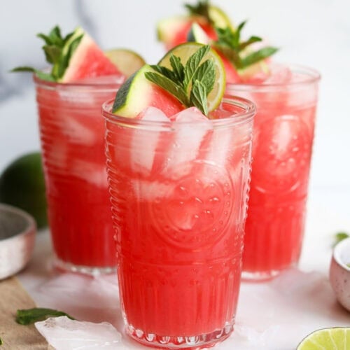 Three tall glasses filled with watermelon mocktail drink