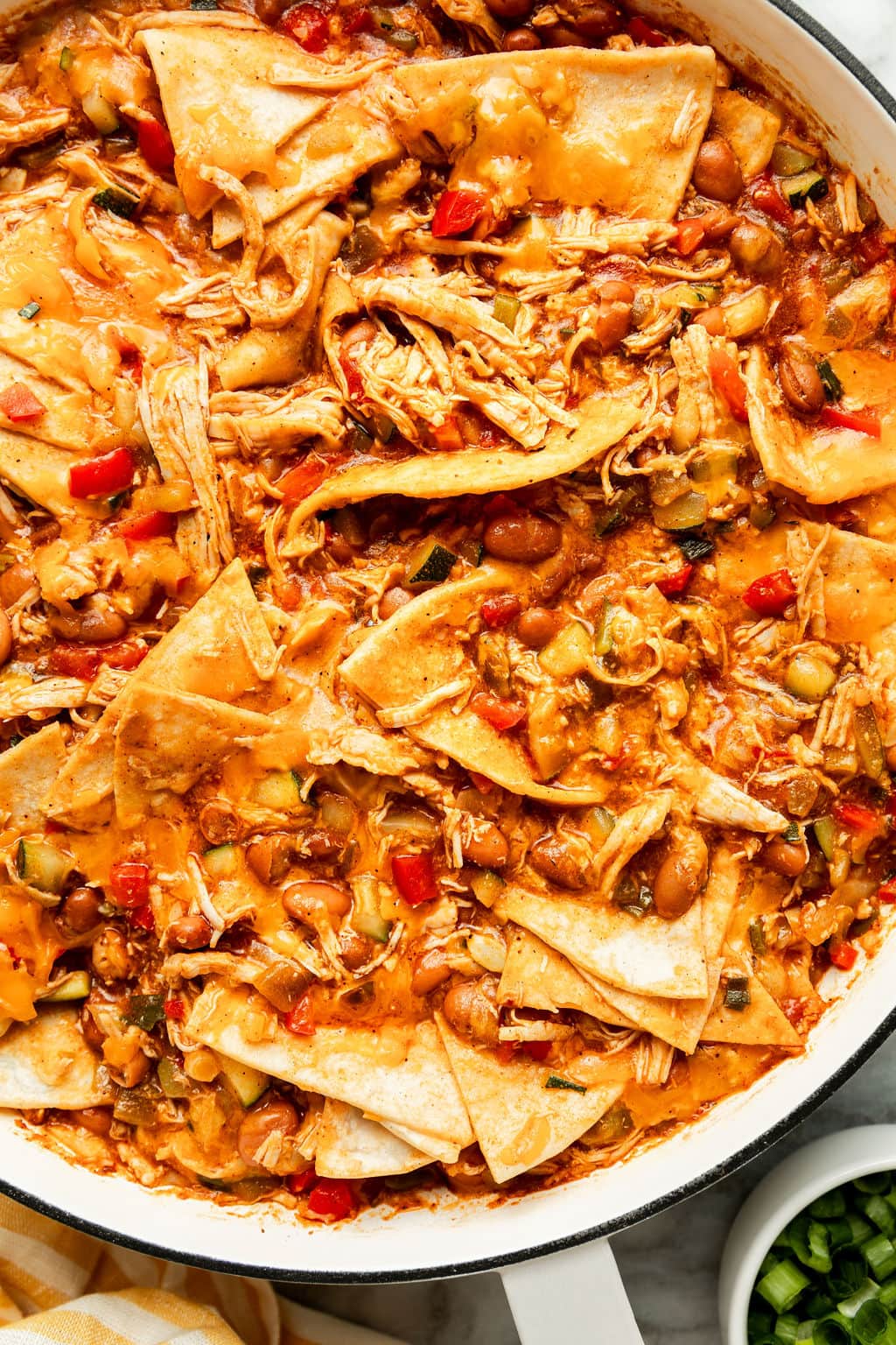 Overhead view of a pan of Easy Buffalo Chicken Enchiladas simmering in a skillet. 