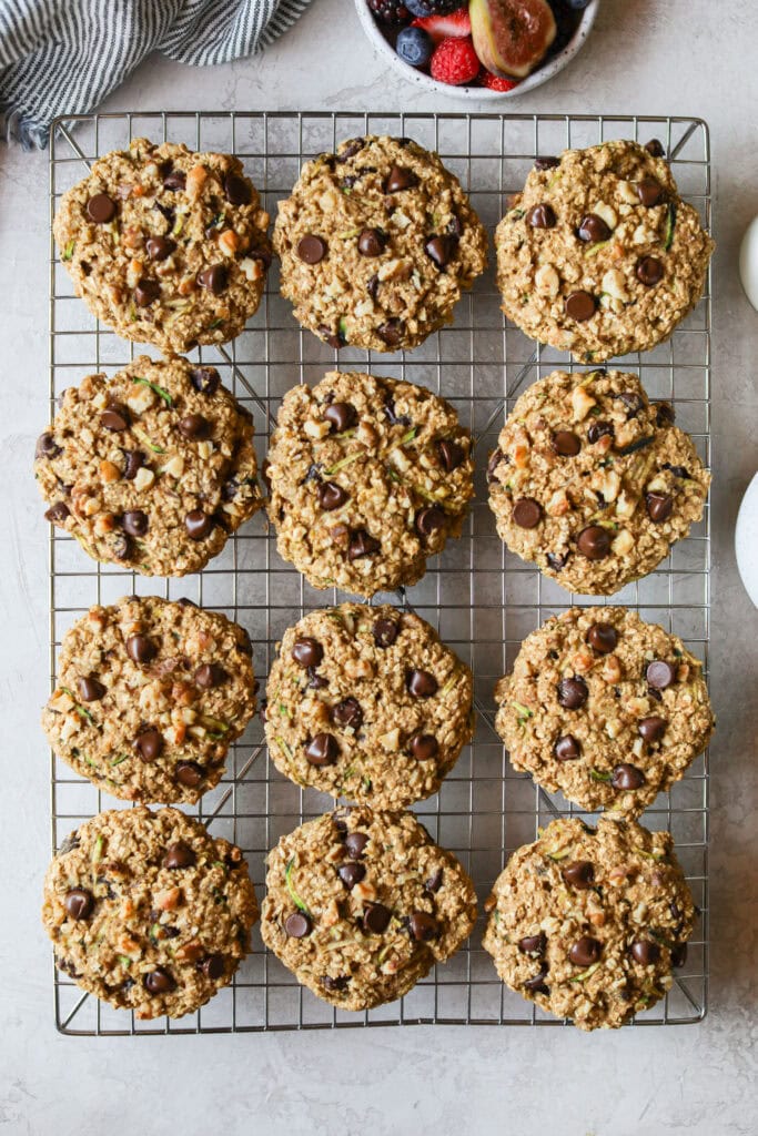 Overhead view of a freshly baked batch of Delicious Zucchini Breakfast Cookies on a cooling rack. 