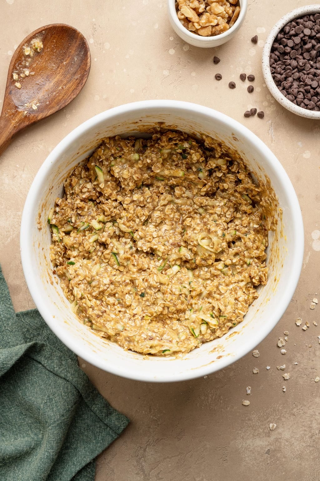 A bowl of raw batter to make zucchini breakfast cookies with oats and chocolate chips.