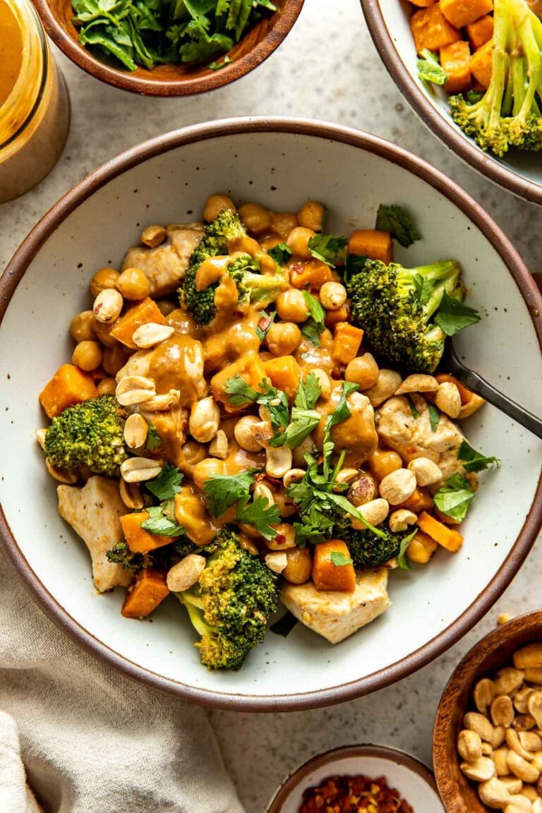 Thai-Inspired Sweet Potato Peanut Bowl with Chicken topped with a drizzly peanut sauce and cilantro. 