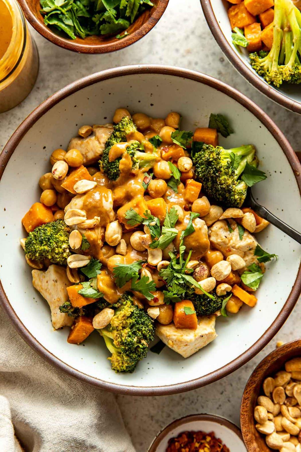 Overhead view of a Thai-Inspired Sweet Potato Peanut Bowl with Chicken topped with fresh cilantro. 