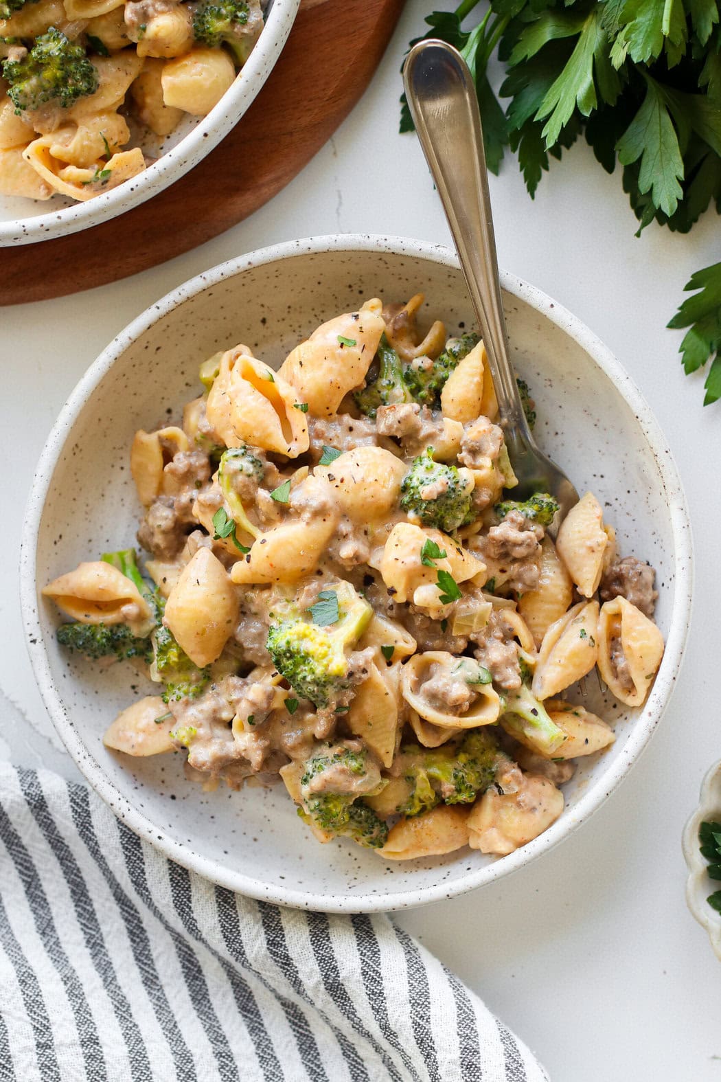 Overhead view of a plate of fresh Homemade Hamburger Helper topped with fresh herbs and black pepper. 