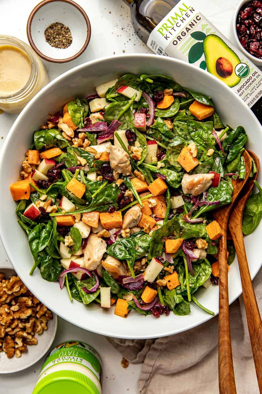 Overhead view of a bowl filled with Harvest Chicken Salad with Maple Dijon Dressing topped with walnut pieces. 