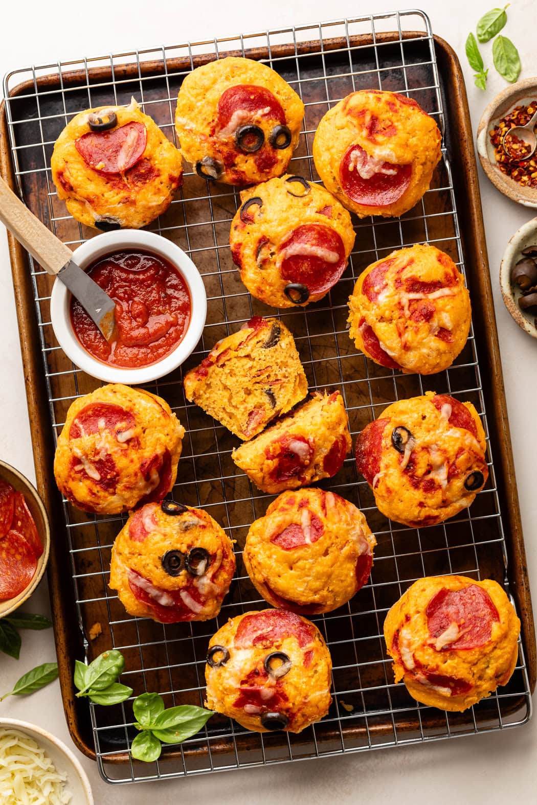 Overhead view of Pepperoni Pizza Muffins on a cooling rack, ready for dipping in marinara sauce. 